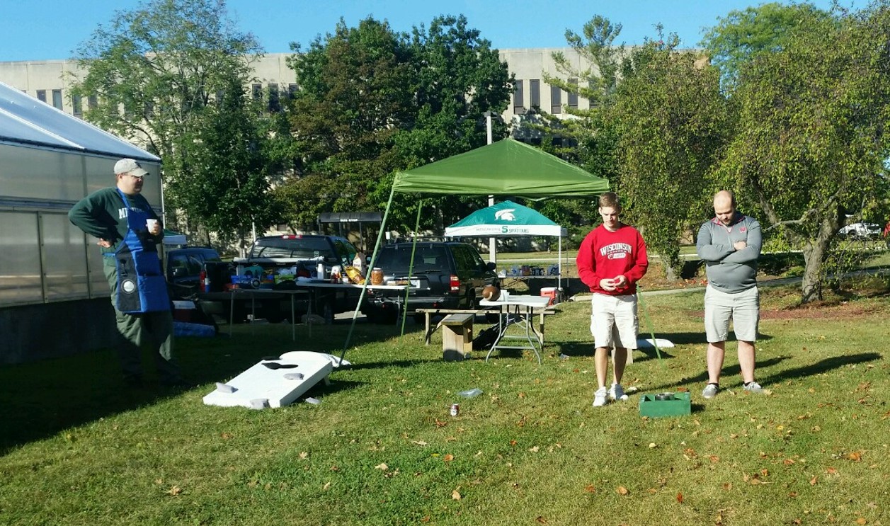 Washer toss game at Michigan State University Microbiology and Molecular Genetics departmental tailgate